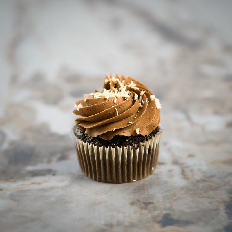 Chocolate cupcake with whipped ganache and white chocolate shavings