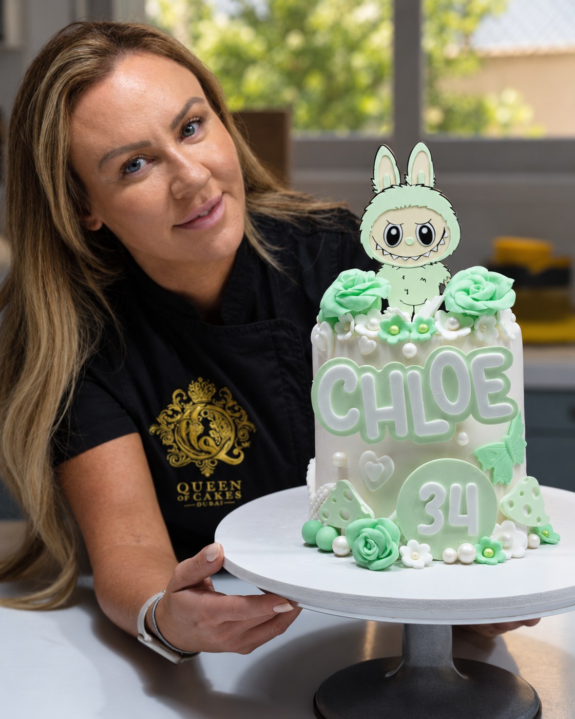 Gemma with a mint-green personalised celebration cake