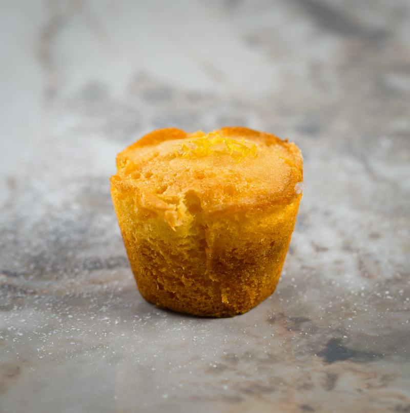 Lemon financier dusted with sugar and fresh zest